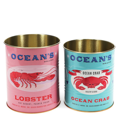 Zwei dekorative Metall-aufbewahrungsdosen "Ocean's Brand" mit Meeresmuster von Rex London, ideal zur Aufbewahrung.