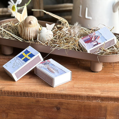 Boltze Manon metal tray with a maritime design, featuring a matching matchbox, displayed on a wooden surface.